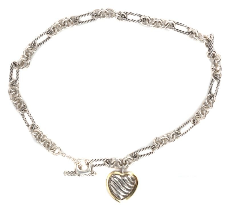 DAVID YURMAN LADIES STERLING & 18KT YG NECKLACE: Classic David Yurman style;16 inch figaro-style chain with toggle featuring 21 by 21mm heart shape pendant with fluted ribs and 18kt yellow gold trim. Size: 16" chain Weight: 48.5 Condition: Very good