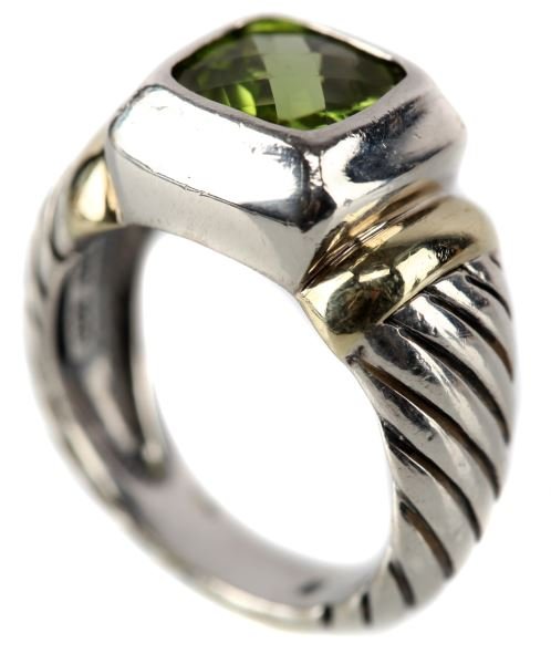 DAVID YURMAN LADIES STERLING & 14K YG PERIDOT RING: Clean lines and flutes make this David Yurman ring a classic; 11.5mm wide at top, containing bezel set, step cut peridot, accented with 14kt yellow gold trim Size: 6.0 Weight: 7.7 Condition: Very good