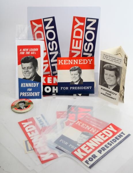 JOHN F. KENNEDY CAMPAIGN ACCESSORIES: Lot includes items from John F. Kennedy's campaign run. Items include Kennedy/Johnson stickers, an inauguration day button with the text "Inauguration Day January 20th-1961 John F. Kennedy 35th Presid
