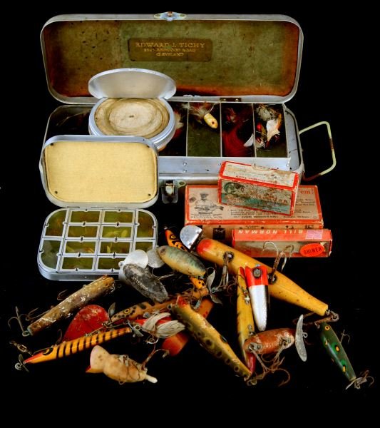 VINTAGE FISHING LURES FLYS TACKLE & BOXES: Grouping of various vintage fishing equipment, including wooden and plastic lures by Heddon and others, pocket size fly box, empty lure boxes, and a small metal chest full of flies and fly equipment.