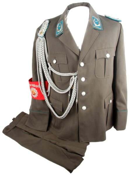 EAST GERMAN AIR FORCE PILOT UNIFORM & ARMBAND: Fairly large size about a U.S. 42, new condition pilot officer uniform, tunic and trousers, shoulder and collar insignia, arm band and shoulder cord.