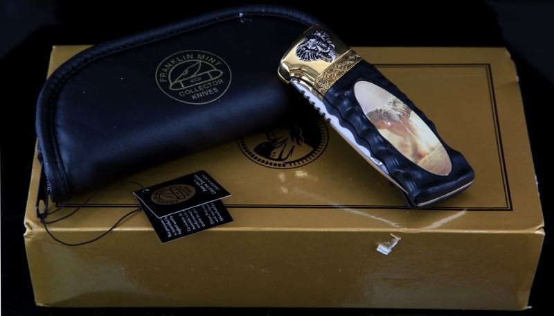FRANKLIN MINT COLLECTOR ELEPHANT FOLDING KNIFE: A powerful showpiece from the National Fish and Wildlife Foundation, collector's knife featuring richly accented 24 karat gold plating. Complete with padded and zippered case and unopened collector po