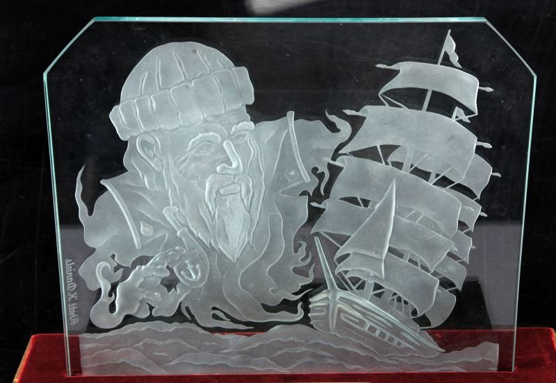 ETCHED GLASS CARVING LIGHT UP MANTLE PIECE: Etched glass carving in a .5 inch plate of glass of a man and a ship set in a display mount with lighting. Mount is plated with the words "Guiding Spirit." Measures in the mount at 18 inches long and 