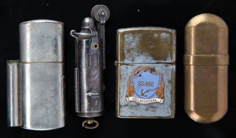 WWI WWII TRENCH & US NAVY SUBMARINE LIGHTER LOT: Collection of four cigarette lighters including a Bowers flip top WWI trench lighter, Brass No. 5 capsule type lighter, WWI French capsule lighter and a WWII dragon Uper lighter from USS Medregal SS48