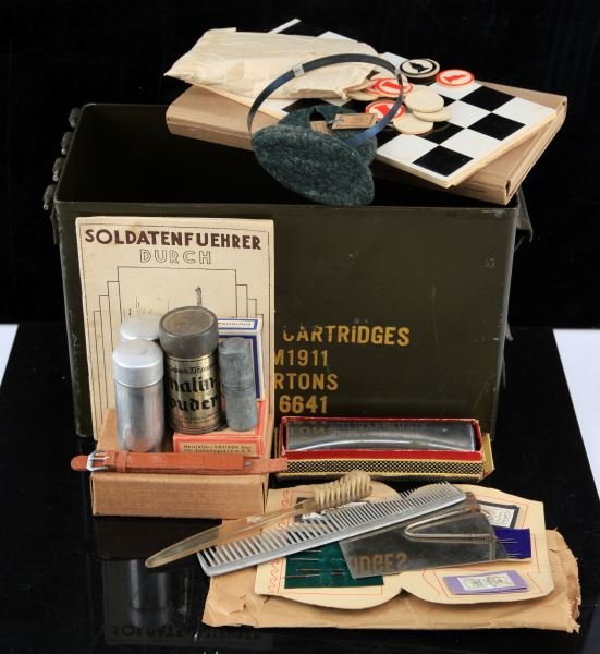 WWI GERMAN SOLDIER PERSONAL RATION COLLECTION: These items are stored in a post war U.S. .45 caliber 1911 ammo can, it includes , Waffenampt stamped unissued watch band, Wehrmacht Feldpost box, Wifeu trench lighter, shaving brush, new old stock So