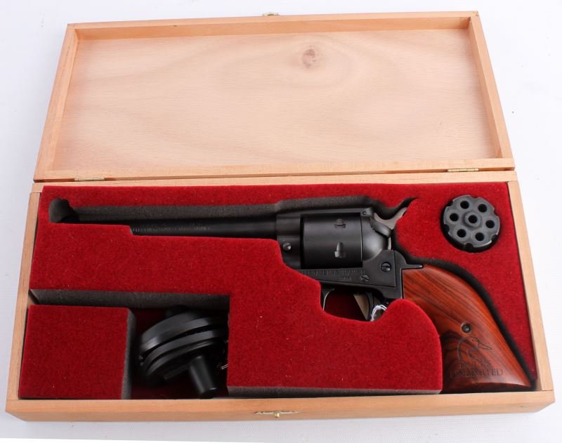 HERITAGE ROUGH RIDER 22 CAL COMBINATION: Heritage Rough Rider with interchangeable cylinders for 22 LR and 22 Magnum. 4.75 inch barrel, blued with wood grips. Comes in wooden presentation box. Overall in excellent condition. Caliber: 22 Seri