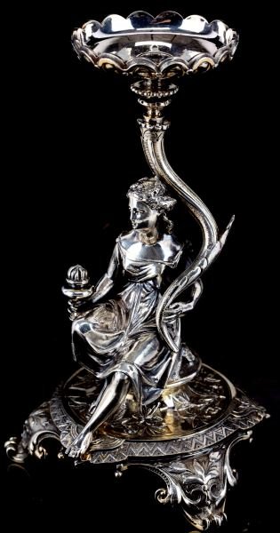 ELKINGTON & CO 1873 SILVERPLATED CANDLE REST: Clearly marked with the Elkington silverplate marks and with a date letter "M" (1873) on bottom "11593" is also present. Finely executed seated female figural candle rest. Round base with three feet. 