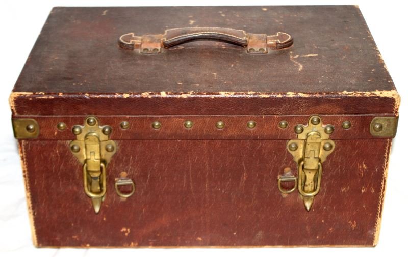 ANTIQUE LOUIS VUITTON PICNIC TEA MOTORING TRUNK: A fantastic motoring trunk by Louis Vuitton dating between 1900 and 1920. Made in black "Vuittonite" with tan interior. Double trays carry picnic supplies including nesting kettle with burner and tea/
