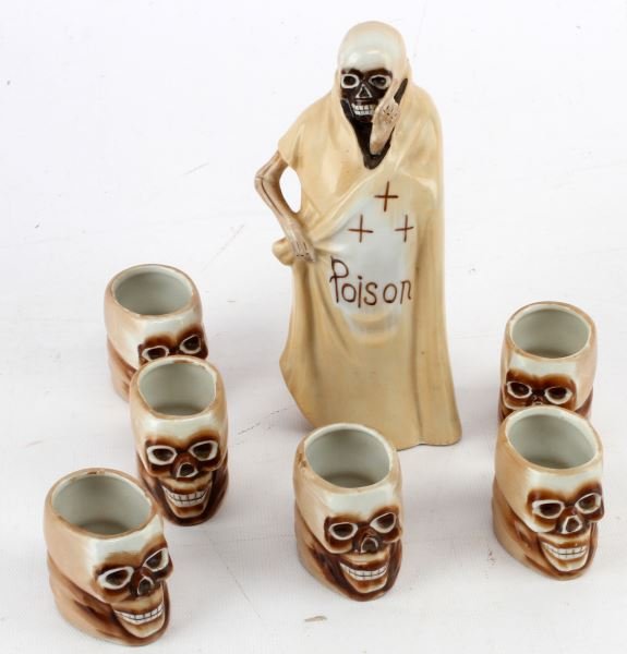1940'S SHOFU PORCELAIN GRIM REAPER POISON BOTTLE: 1940's Shofu Porcelain Grim Reaper Poison bottle with 6 sake shot glasses. The bottle stands at approximately 6.5 inches tall and shot glasses are 2 inches high. No cracks or detractions in very good 