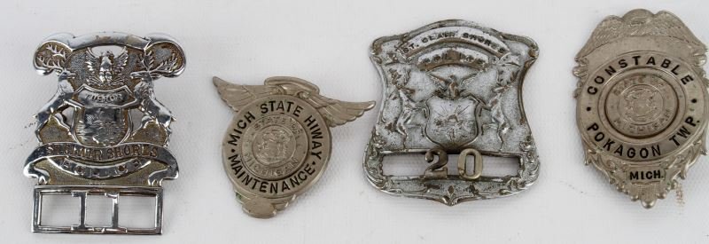 GROUPING OF 4 OBSOLETE MICHIGAN POLICE BADGES: Included are two early badges from St. Clair Shores, MI. numbers 11 (screw back) and 20 (pin back [broken]). There is also a Pokagon Twp. "Constable" badge (pin back) and a "Mich state Hiway Maintenan