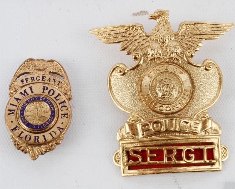 TWO OBSOLETE SERGEANT BADGES MIAMI & WISCONSIN: Included is a Miami, Florida Sergeant wallet badge 2 inches long. Marked on the back with "Donald Lavigne, Inc. Miami, Fla". Two piece badge features enamel disc in center with Miami Dade emblem. Also