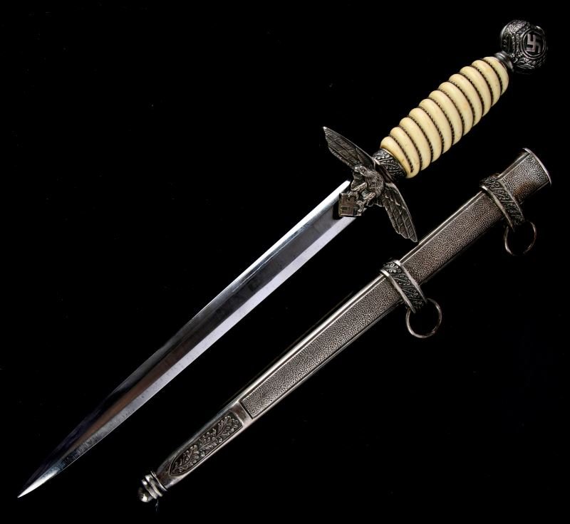 WWII GERMAN LUFTWAFFE SECOND MODEL DAGGER: WWII German Luftwaffe Second Model dagger. Blade marked "Paul Weyersberg & Co. Solingen". Dagger looks to be refinished with damage and signs of repair to top hanger. Overall in good condition.