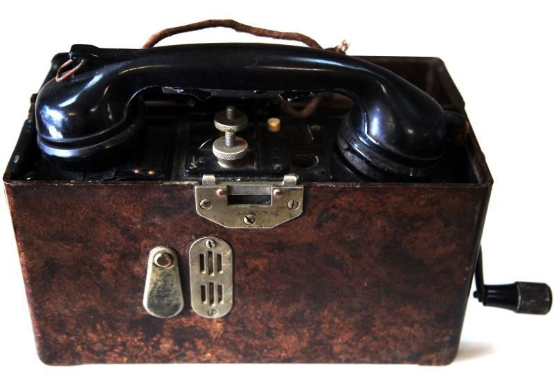 GERMAN WWII WEHRMACHT FIELD TELEPHONE RADIO: 1938 German Army field telephone in medal box measuring 10.5 by 3.5 by 8.5 inches with snap top, template, screwed on the top of box lists code for letters. Cord of phone is worn, otherwise in very go