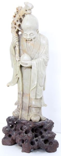 CHINESE SOAPSTONE CARVING GOD OF LONGEVITY: Soapstone carving the Chinese God of Longevity holding a staff in his right hand and a peach in the other. Very intricate detail mostly on the face and staff. Measures approximately 13.5 inches tall. 
