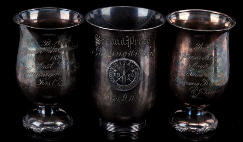 THREE SILVER PLATED LATE 1800'S TRACK TROPHIES: Three track and field trophies consist of one 1893 Junior Championship running high kick, one 1893 Junior members first prize running broad jump, and one 1895 second prize putting 16lb shot. Overall i