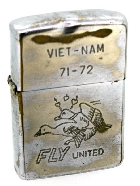 VIETNAM 71-72 FLY UNITED ZIPPO LIGHTER: Original Zippo with with famous Fly United goose scene, reverse female holding bird and inscribed Chad, a dent to top and some finish loss, the top is a little loose but still clicks shut.