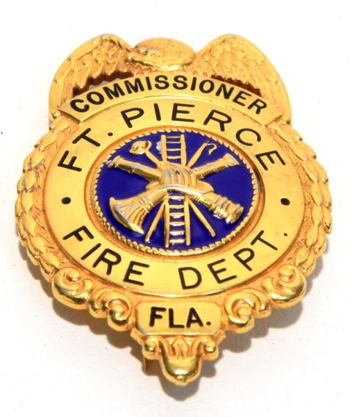 OBSOLETE FORT PIERCE FIRE COMMISSIONER BADGE: Smooth back vertical pin 2.5 inch badge. Forged two piece construction weighs 40 grams. Very good condition with some wear to high points on surface.