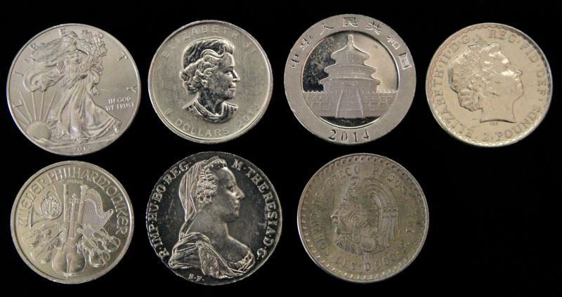 EAGLE MAPLE PESO PHILHARMONIC PANDA 2 POUND COINS: Seven different brilliant uncirculated silver one OZT silver minted coins, includes Austria Marie Theresa, Britannia 2013 two Pound coin, 2014 Chinese Panda, 1948 Cinco Mexican Peso .90 Ley, 2013 Silv