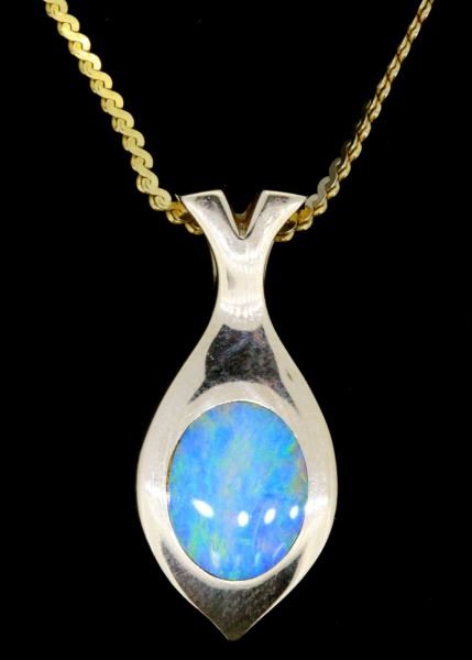 LADIES 14KT YELLOW GOLD OPAL PENDANT: high quality oval shape opal, deep bright blues and green,9x7mm, bezel set into solid back gold pendant setting23mm high, 10mm wide, 2.25mm thick. 15 inch serpentine chain included. Size: 15 inch chai