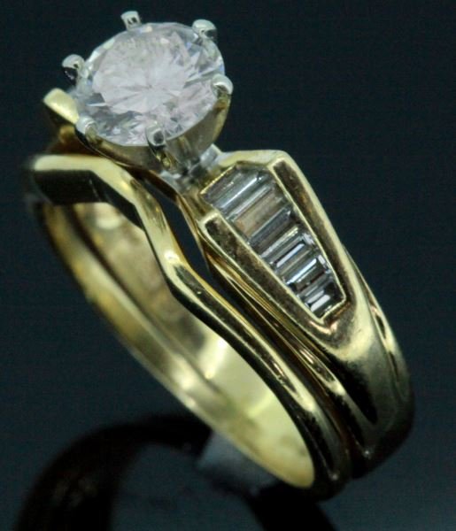 LADIES 14KT YG DIAMOND BRIDAL SET 1.70CT TW: Two piece bridal set; classic "bow-tie" design, seven baguette cut diamonds channel set on each side of center. Center diamond measures 6.5 x 3.85mm for approximate weight of 1.03ct., graded G/SI2, wi
