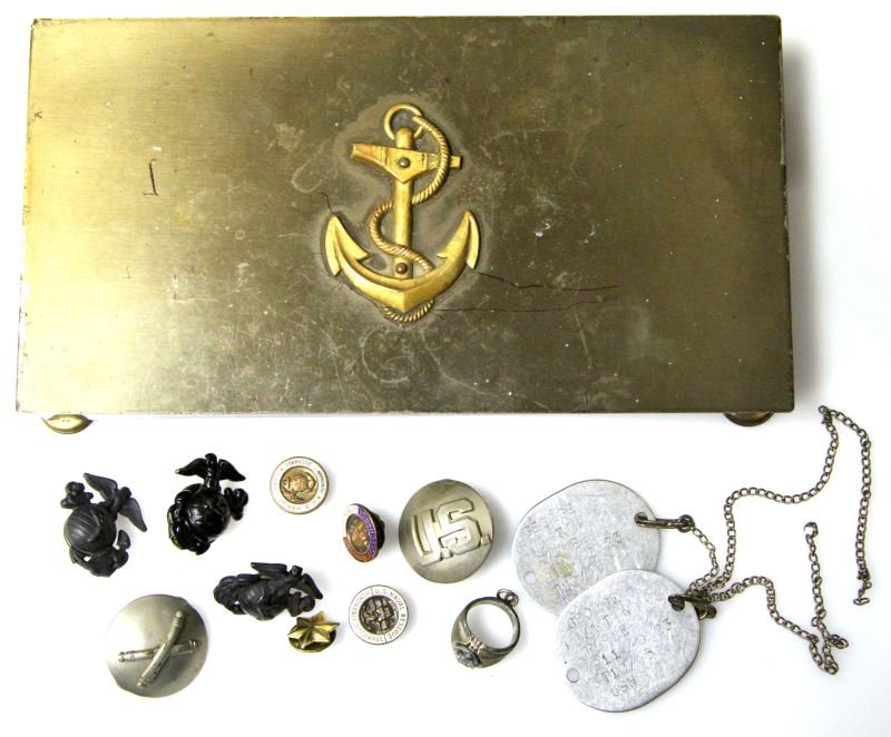 US NAVY BOX WITH USMC ARMY EGA'S AND PINS: Dog Tags, three EGA's, Army ordnance pins, USMC discharge pins, USN sweetheart ring, all contained in a Naval Anchor box.