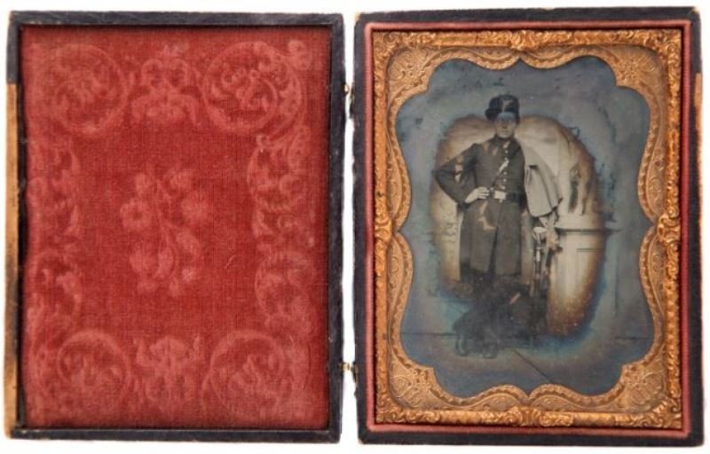 CONFEDERATE INFANTRY SOLDIER 1/4 PLATE AMBROTYPE: Quarter plate of a Confederate Infantry soldier leaning against his sword and a pillar statue on it. He has Infantry bugle cap device a square belt buckle and what appears to be a Confederate foot sol
