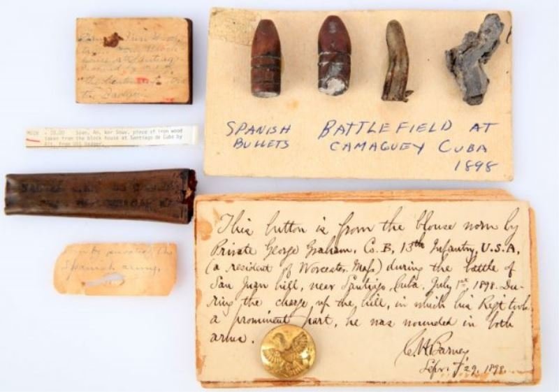 SPANISH AMERICAN WAR BATTLEFIELD ARTIFACTS: Three items of interest to include , a small piece of wood with attached description as follows "Piece of iron wood taken from the block house at Santiago de Cuba by a LT. from the USS Badger", next i