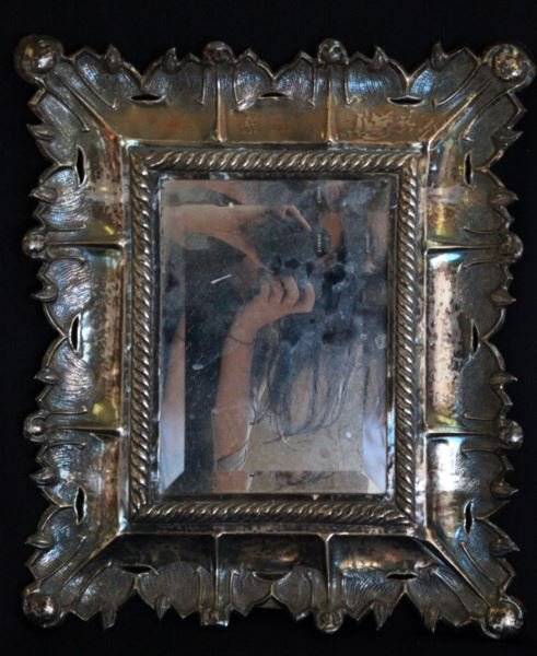 PERU 925 ANTIQUE HAMMERED SILVER BEVELED MIRROR: Measuring 15.5 by 18 inches, stamped 925 Peru MMH at upper right corner, has very old hand crafted wooden frame behind the silver with a latch to remove mirror and replace with something else, difficu