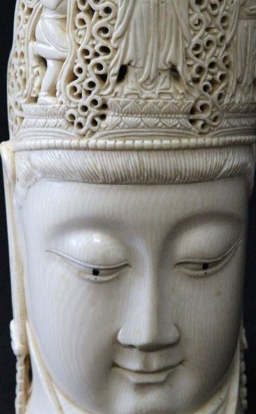 CARVED ELEPHANT IVORY MEDITATIVE QUAN YIN HEAD: Quan Yin head is carved from a tusk and features intricate carvings throughout. Top center of crown is missing a half inch section. Overall in very good condition. This lot can only be shipped within 