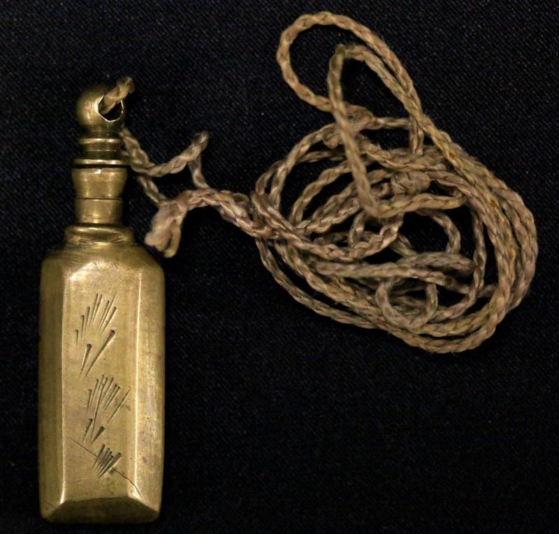 VINTAGE SOLID BRASS OPIUM BOTTLE: Measuring 61mm high,17.5mm wide and 8.85mm thick, hand engraving on front and back, solid brass opium bottle in good condition; tip of scraper broken. Weighs 23.5 grams.