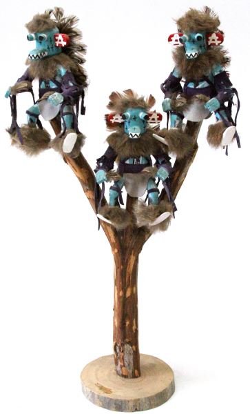 NORTHWEST COAST INDIAN NAVAJO KACHINA DOLL ART: Three Navajo Kachina doll family mounted on a tree limb and base. Measures at approximately 18.5 inches tall. An earpiece is missing from one of the Kachina's otherwise in good condition.