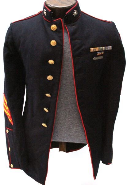 USMC WWII POCKETLESS TUNIC WITH PATCHES & RIBBONS: Small size dress blue tunic with no pockets. 1st Division Amphibious Corp. HQ patch with red border. (Australian made). Tech. SGT. Rank. Three campaign hash marks on right sleeve. Some damage to botto