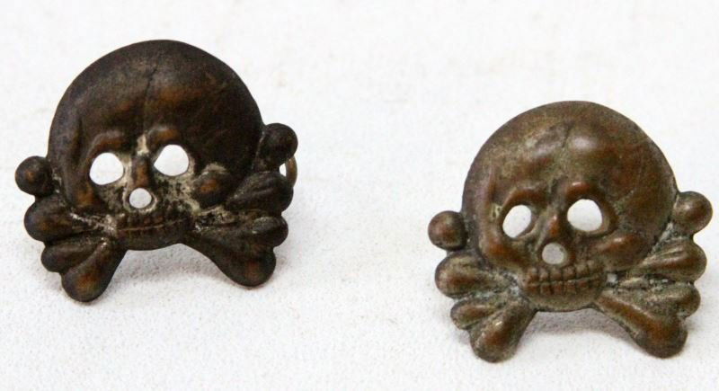 TWO AUTHENTIC TOTENKOPF DEATH HEAD VISOR INSIGNIAS: WWII German NAZI SS totenkopf death head insignias. Both look to have been buffed a long time ago, with very little of the silver patina left. Both have two connecting prongs. Overall in good to very