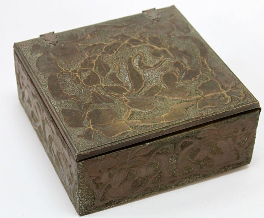 TIFFANY & CO 1910 STAMPED ARTS & CRAFT PERIOD BOX: Hammed copper over wood, stylized floral design, T&C Chicago, with 1910 patent on bottom, measures 7x7x3 inches, some separation on one side and the latch has an old repair, otherwise good.
