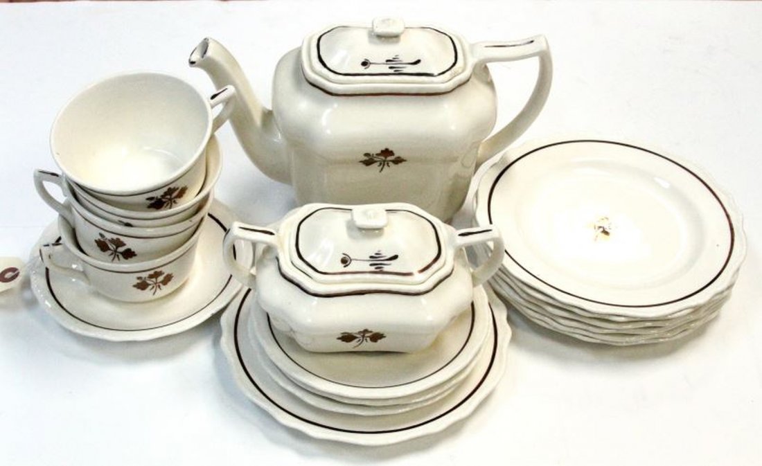 17 TEA LEAF IRONSTONE CUMBOW TEA SERVICE PIECES: Included is a 6 inch Tea pot (chips to lid,foot and spout), sugar (repaired handle and cracked), four tea cups ( some crazed and stained), four saucers (1 chipped) and seven dessert plates (7.5 inches