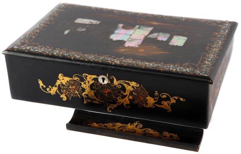 VICTORIAN LACQUERED PAPIER MACHE WRITING SLOPE: Victorian era black lacquered papier mache writing slope. Gilded floral design. Red felt interior with Mother of Pearl inlay atop. Measures 12 by 9 inches. Crazing throughout, overall good condition.