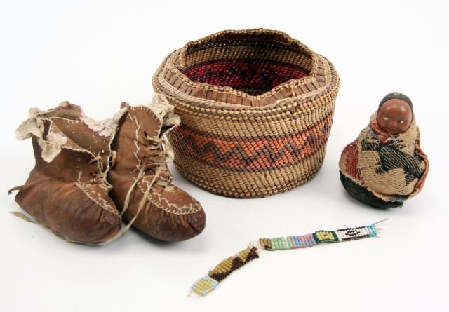 LOT OF VINTAGE NATIVE AMERICAN INDIAN ARTIFACTS: Lot of vintage Native American items; small Makah basket without lid (5 inch diameter, 2.5 inches tall), pin cushion doll (3 inches tall), leather moccasin hand stitched booties with lace trim (4 inch