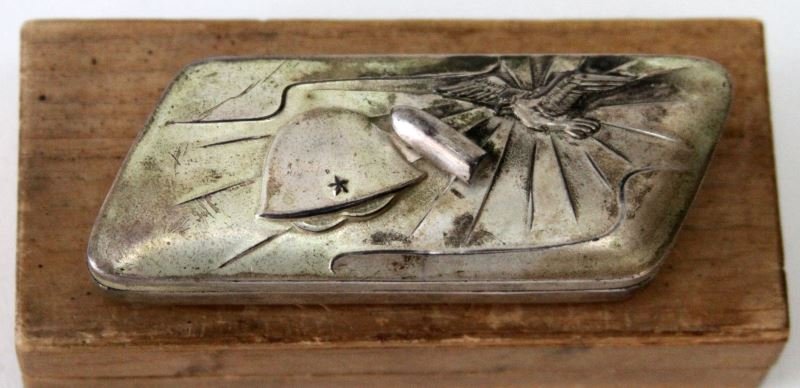WWI JAPANESE ARMY ARTILLERY OFFICER INSIGNIA BOX: Measuring approximately four inches, silver plate with IJA helmet, Artillery shell and eagle, well crafted, presumed an insignia container, in wooden box not believed original to the piece.