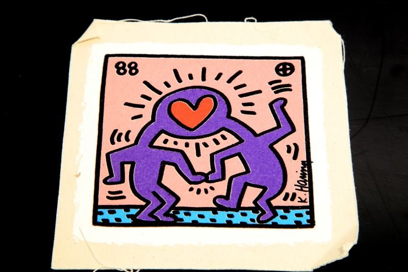 KEITH HARING SILK SCREEEN INVITATION DR WINKIE DV8: Keith Haring (American, 1958-1990) silkscreen on canvas wedding invitations featuring Haring's untitled 1988 design with two figures sharing a head with heart on pink field. Invitation measures approx
