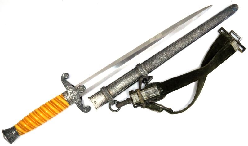 GERMAN NAZI ARMY OFFICER DRESS DAGGER WITH HANGER: Blade marked with Puma logo and "Solingen". Pebble paneled metal scabbard (lower hanger ring is loose). Orange handle. Throat washer is present. Dagger and scabbard are in very good to excellent condi