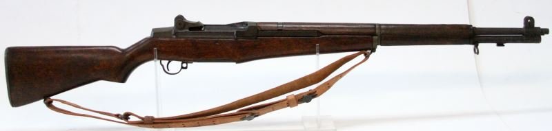 WWII US SPRINGFIELD MODEL M1 GARAND RIFLE: Bore is clean, Stock shows some bruises. Manufactured Jan. 1944. Cleaning kit is intact in butt plate. Receiver cover appears to be early replacement. Leather sling is marked "Boyd 42".