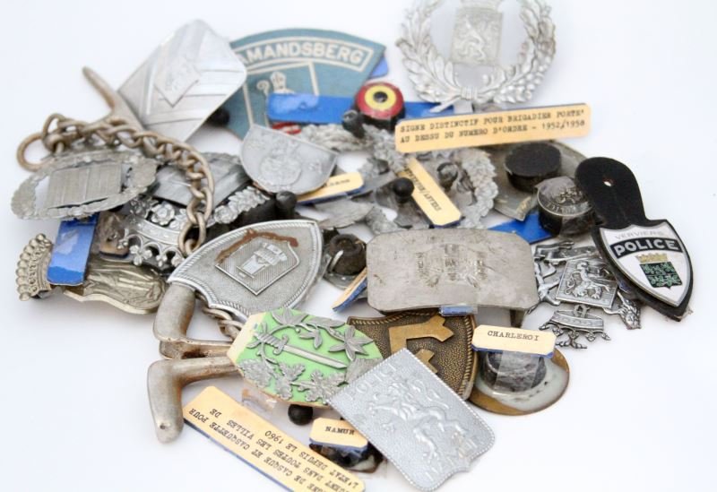 WORLD POLICE BELGIAN CAP BADGE LOT MID CENTURY: From the World Police Museum in Milan, Italy. Circa mid 20th century. Group includes: cap/helmet badges, shoulder pins, breast badges, buttons, belt buckle, and patch. Many with King's crown, Lion's R