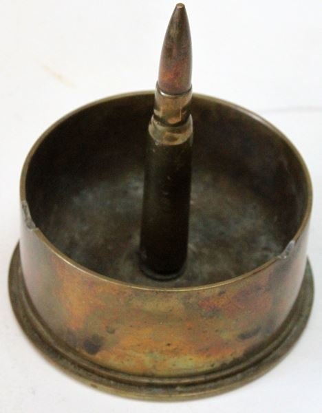VINTAGE WWII TRENCH ART 90MM SHELL ASHTRAY: Weighing 3.45 pounds, measuring 5 1/8 inches in diameter at base. Marked "90MM M19", "LOT 2-1300-19" and "S.M.C. 1941" on bottom of piece. In good condition. This lot has a reserve.