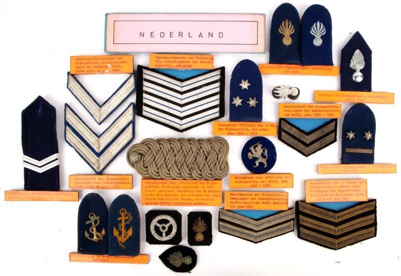 GROUP OF NEDRLAND POLICE OF WATER PATCHES, BOARDS: Group of 18 ranking patches, shoulder boards, collar tabs, and collar insignia of the Nederland national police of water. Group is all composite board backed. From the World Police Museum, Milan, Ital