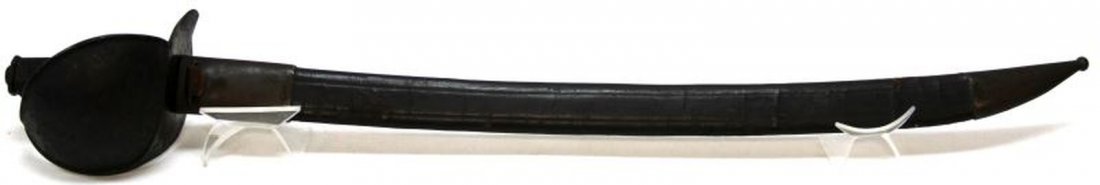FRENCH M1801 NAVAL CUTLASS SWORD & SCABBARD: Having had proof marks removed. 26.5 inch blade 33 inches overall in scabbard. Japanned iron cup hilt and grip with some original finish still remaining. Japanned leather scabbard with brass chape and