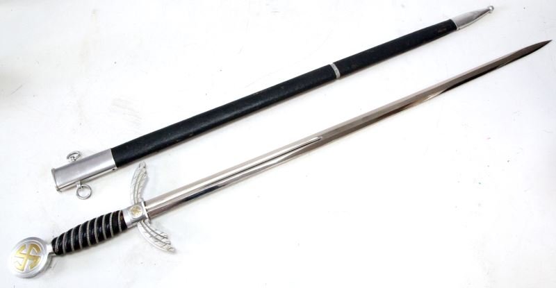 GERMAN WWII LUFTWAFFE FIRST PATTERN OFFICERS SWORD: WW2 German Luftwaffe Sword by Paul Weyersberg Solingen. Oak leaves on edge of pommel, "sun wheel" swastika on the round nickeled pommel and center of the "winged" crossguard.. Wire wrapped leather gri