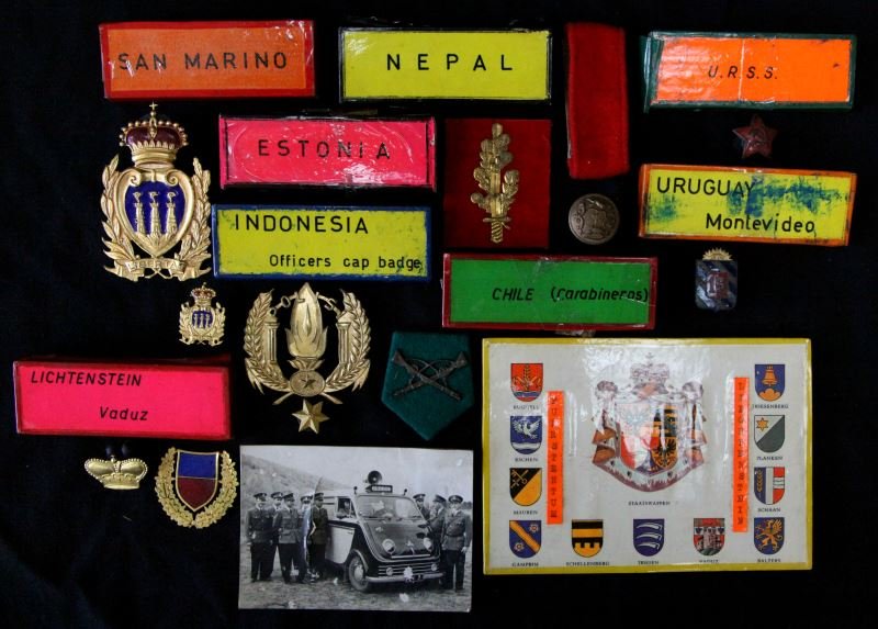 ESTONIA CHILE URUGUAY NEPAL POLICE INSIGNIA LOT: The six items in this collection are from the World Police Museum, in addition to the titled named countries also include San Marino and Indonesia, USSR, and Lichtenstein, buttons and badges from vari