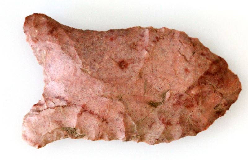 LATE PALEO PERIOD QUAD ALABAMA ARROWHEAD: Basal ground, strawberry chert, Paleo quad, measuring two inches, from long time Alabama collector of Indian lithic artifacts, new to the market.