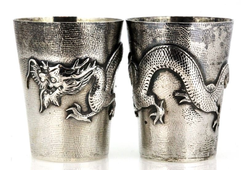 ANTIQUE .900 SILVER CHINESE DRAGON SHOT JIGGERS: .900 silver, 2 1/4 inches tall, mouth 1 3/4 inches in diameter, base 1 3/16 inches in diameter. Marks on bottom relate to Sing Fat, Chinese silversmith from early 20th century. All hand hammered, appl