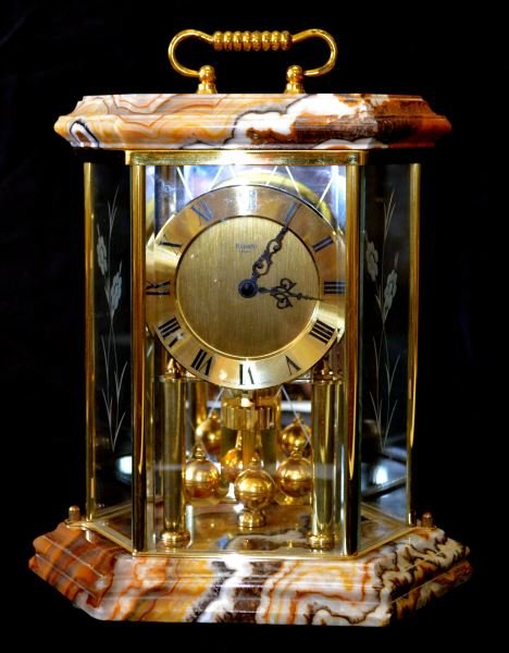 VINTAGE KUNDO ANNIVERSARY CLOCK W/ JASPER TOP/BASE: Battery operated movement, reproduction of older anniversary model. Top and base are solid pieces of Jasper. Glass is acid etched. Weighs 9.3 pounds.